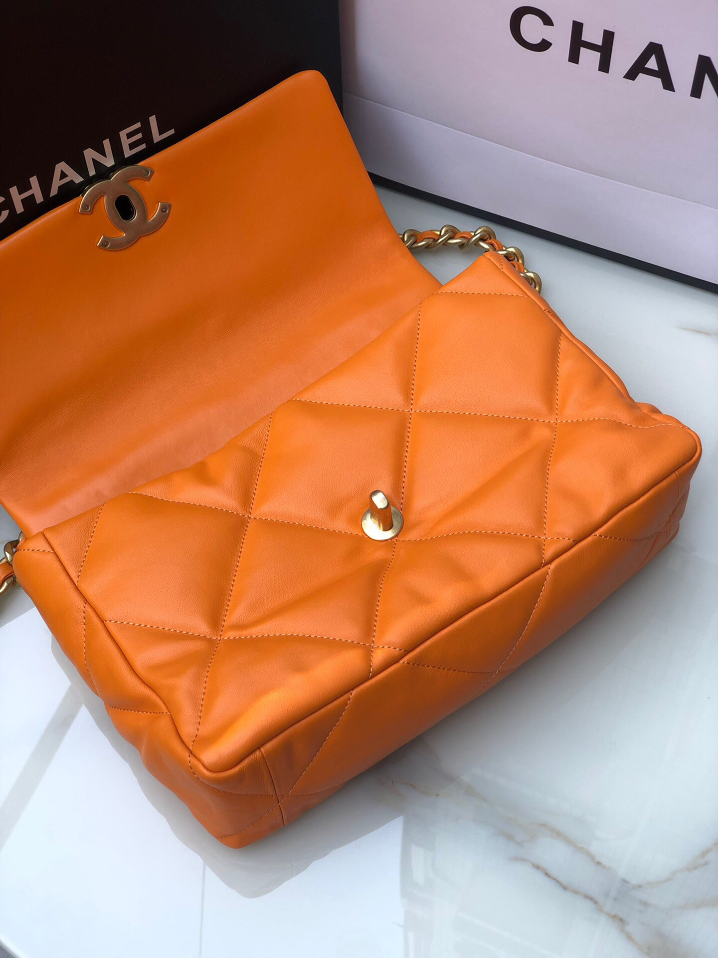 Ch*el 19 large handbag shiny leather, gold-tone, silver-tone & ruthenium-finish metal orange 7.8 × 11.7 × 3.9 in